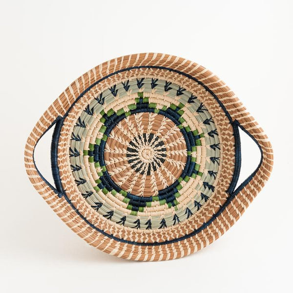 Round pine needle basket with handles in green dyed and undyed raffia